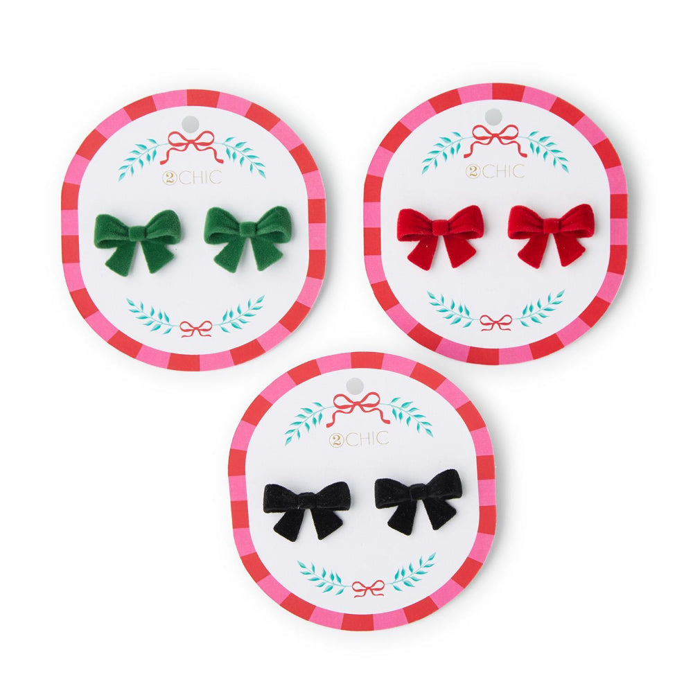 Three pairs of colored bow-shaped earrings in green, red & black on branded card packaging with a white background.