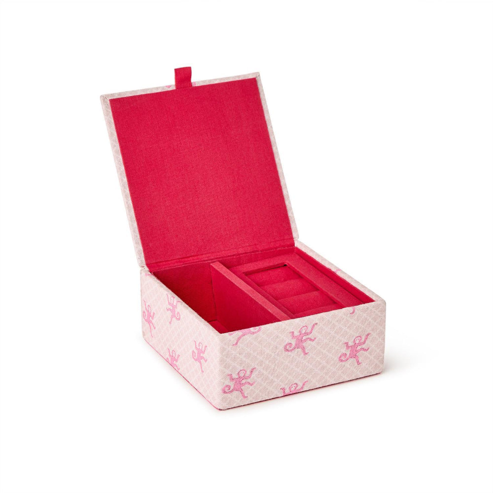 A square jewelry box with an open lid, featuring a bright pink velvet interior and a light pink patterned exterior with small pink bows.