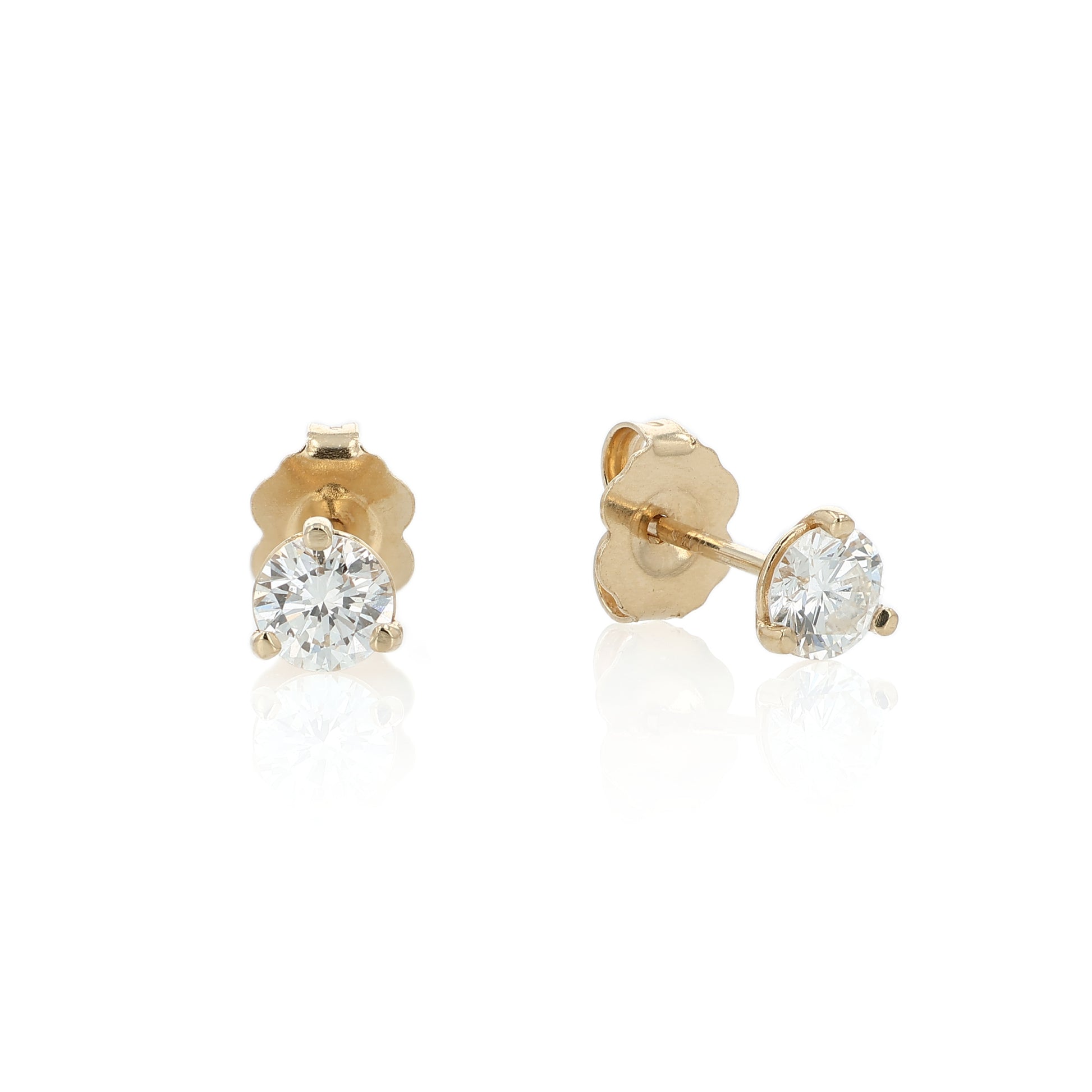 Yellow gold round brilliant cut diamond studs totaling 0.57 carats on a white background