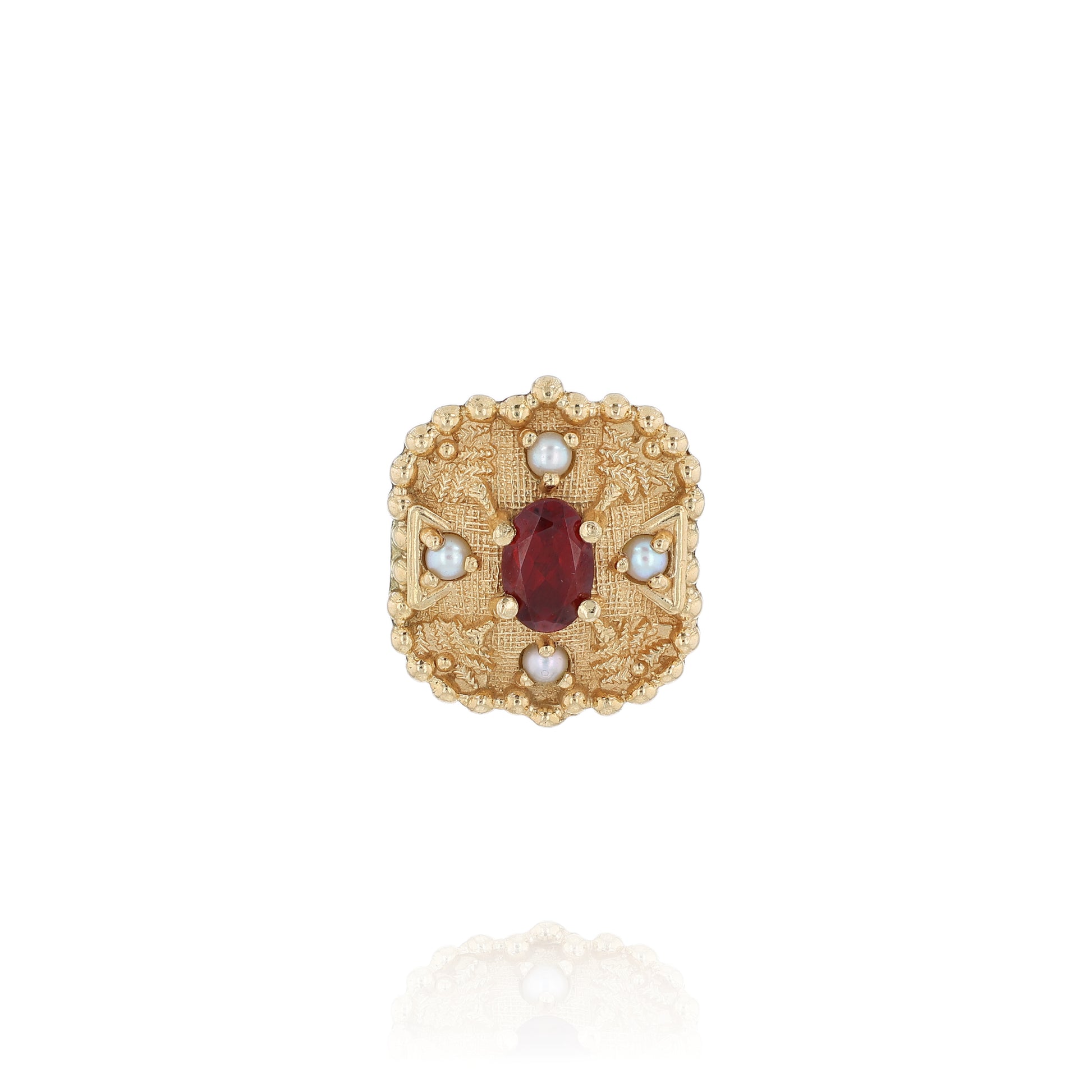 Yellow gold slide pendant with an oval garnet center and surrounding pearls on a white background