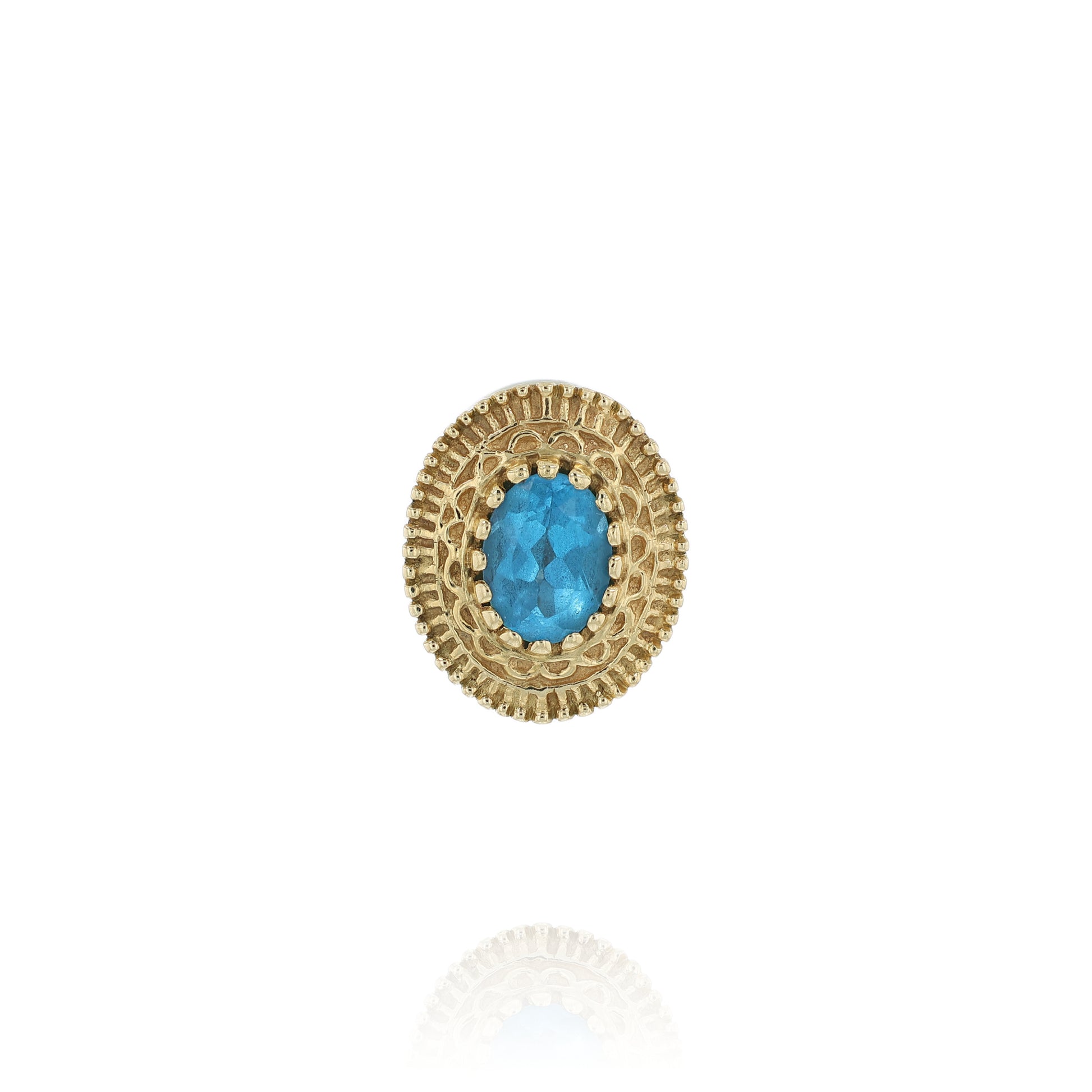Yellow gold oval blue topaz slide charm pendant with a textured front on a white background