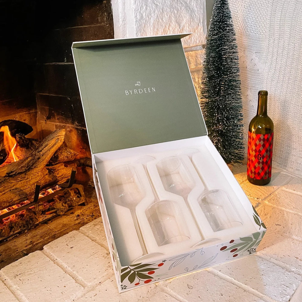 Gift box with Byrdeen branding in front of a fireplace with Christmas decorations.