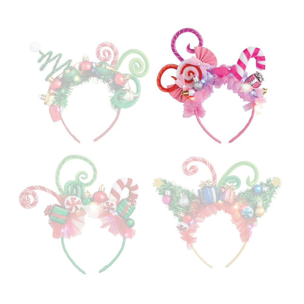 Pink festive headband with candy cane designs and christmas ornaments on a white background.
