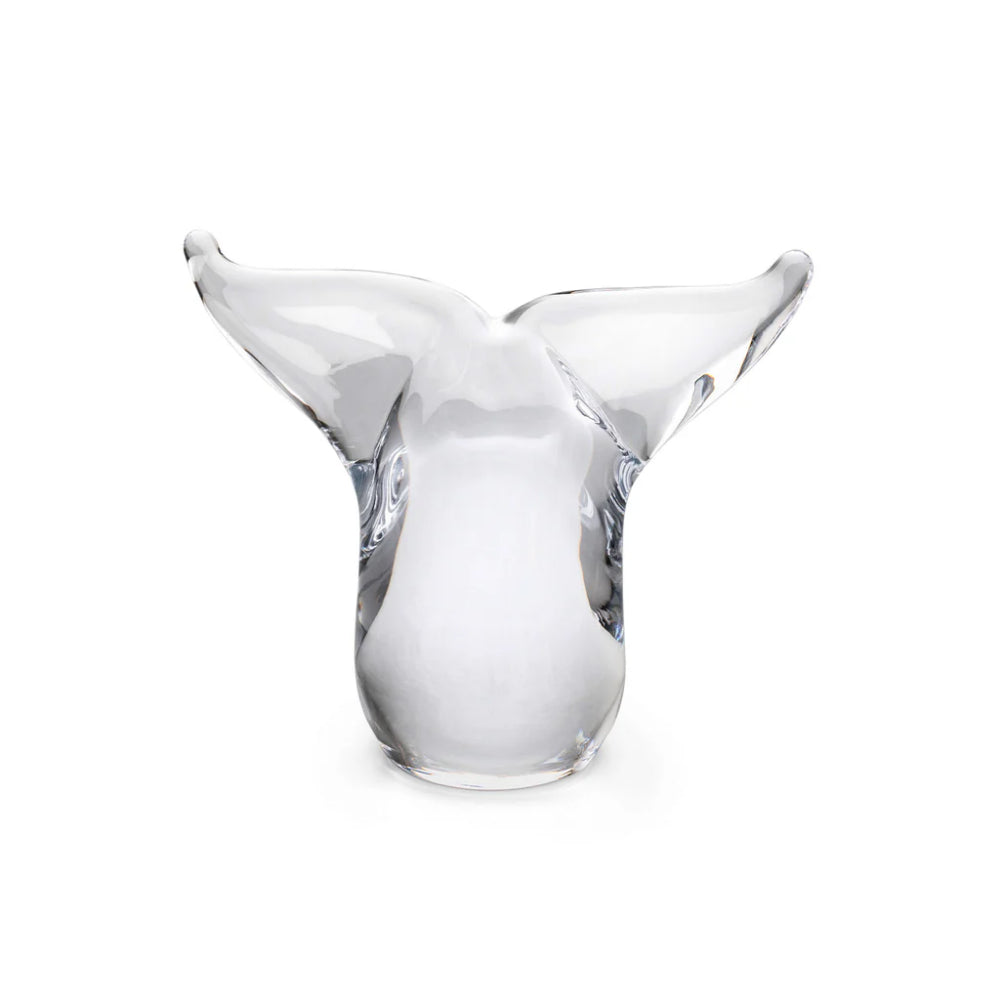 Clear glass Simon Pearce Whale Tail on a white backround.
