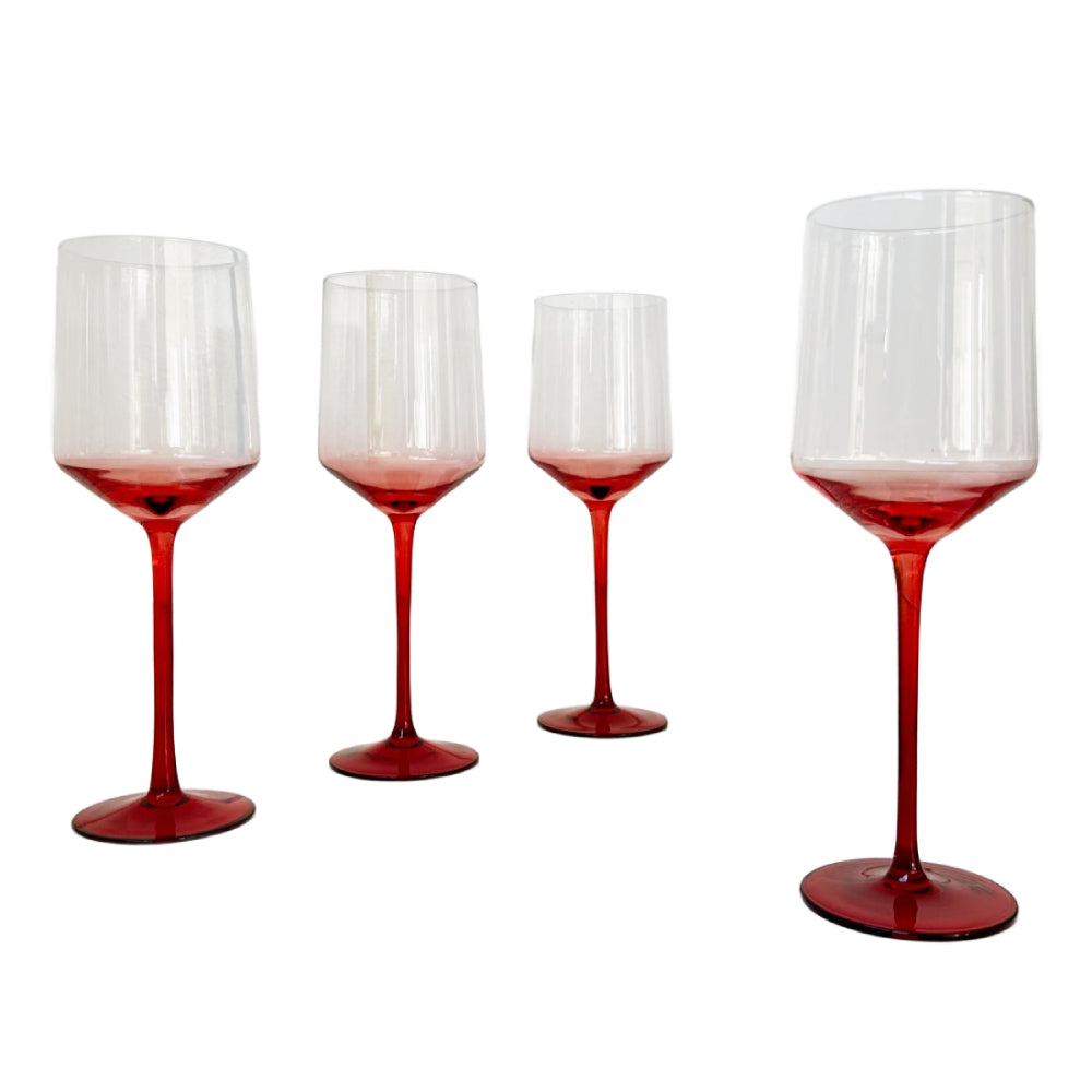 Four clear wine glasses with a vibrant red gradient at the base and stems, shown on a plain white background.