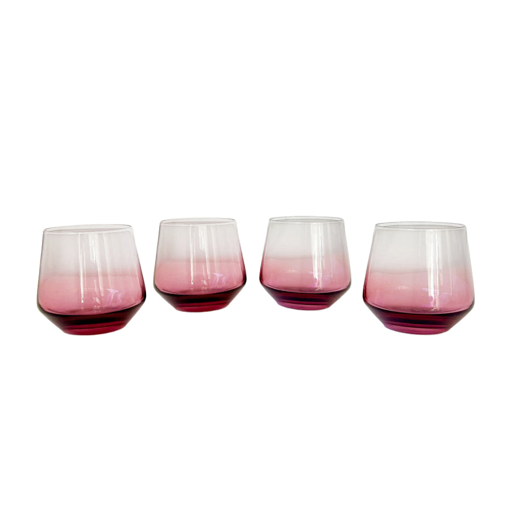 Four stemless wine glasses with a pink-to-clear ombre gradient and deep magenta bases, arranged in a row on a white background.