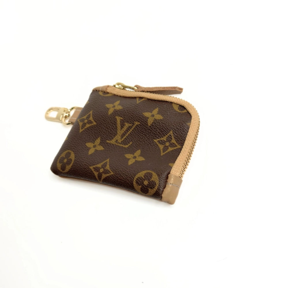 Louis Vuitton coin purse with monogram pattern on a white background