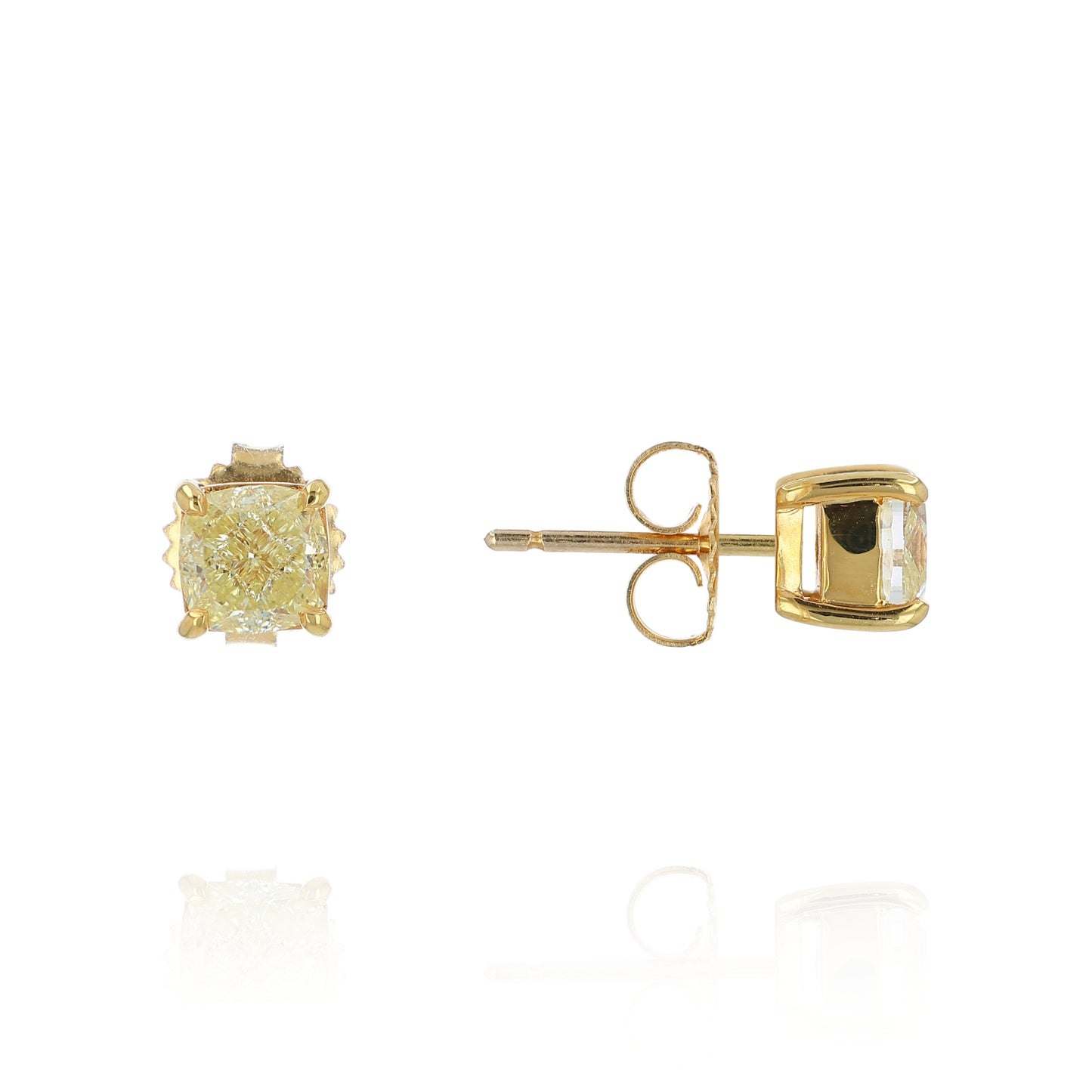 A pair of yellow gold stud earrings with cushion-cut fancy yellow diamonds, shown from the front and side on a white background with a soft reflection.