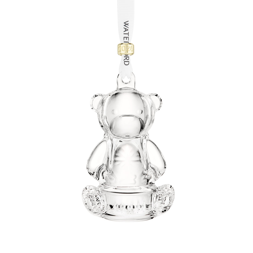 Clear glass bear-shaped ornament with a white ribbon on a white background