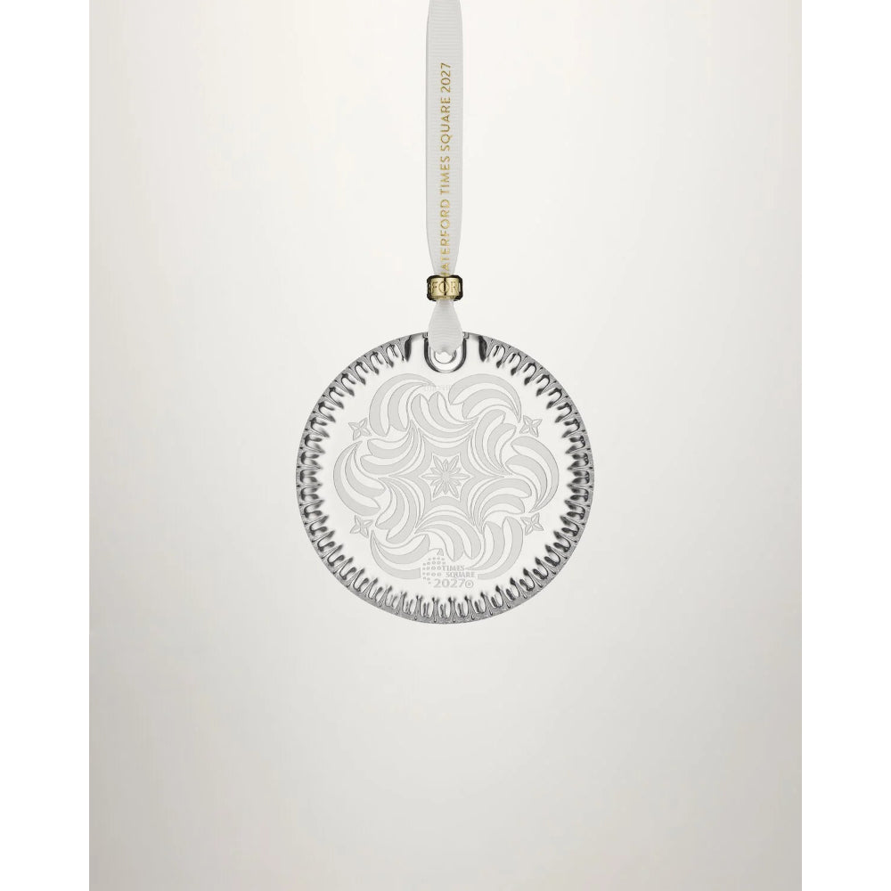 A clear circular hanging ornament with an etched floral pattern and a white ribbon loop printed with 'Oxford Three Square 2027' in gold, shown against a light gray background.