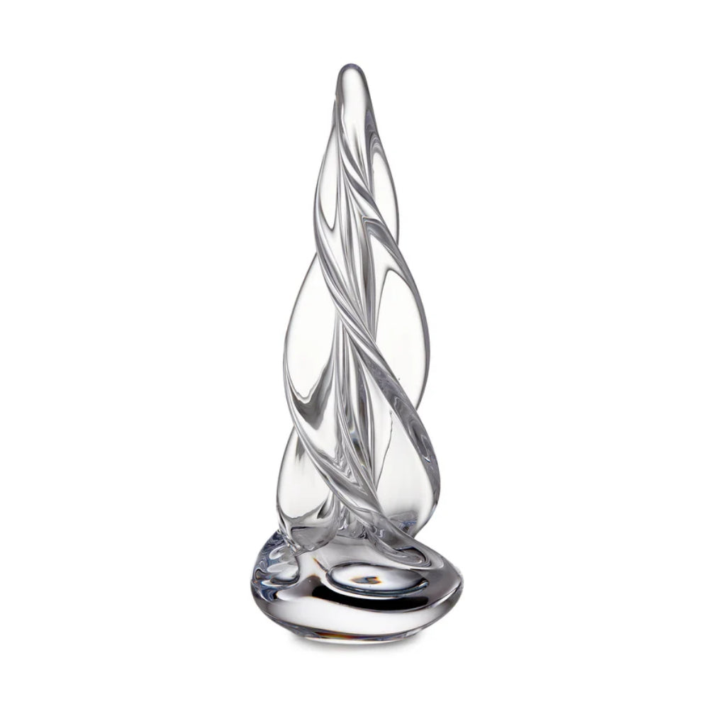 A clear glass sculpture with a twisted, flame-like form on a round base, photographed against a plain white background.