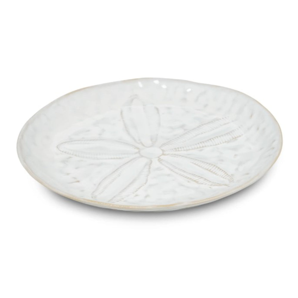 White ceramic plate with decorative pattern on a white background