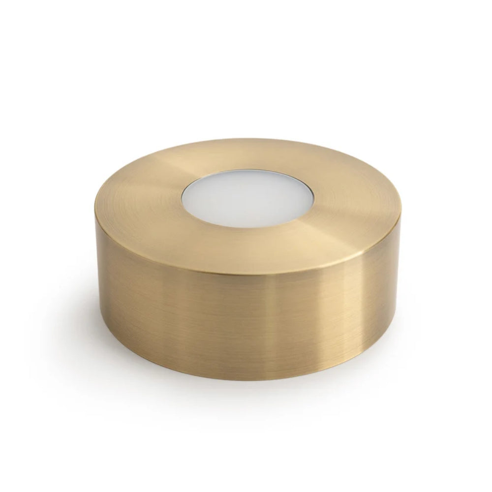 A large brass cylindrical light fixture on a white background.