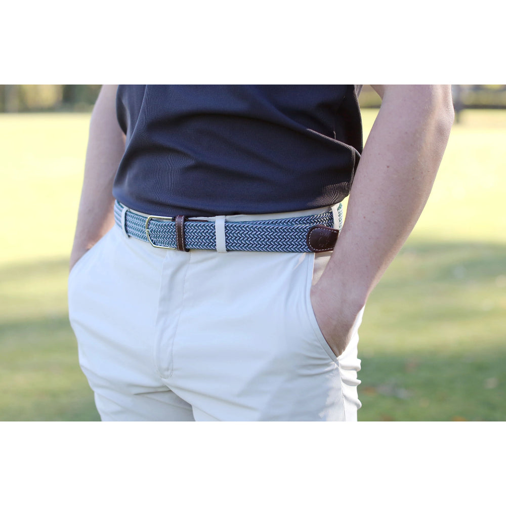 Roostas green & white Brandon Woven Belt worn by a person with kaki pants and a navy blue shirt outside. 