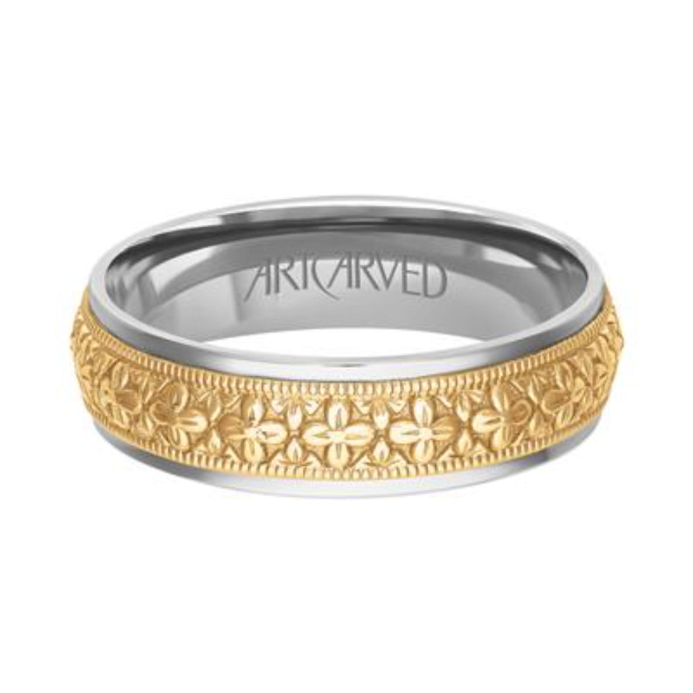 A two-tone ring band featuring a textured yellow gold floral milgrain outer band and a polished silver-toned inner band with the brand name 'ARTCARVED' engraved inside, shown on a plain white background.