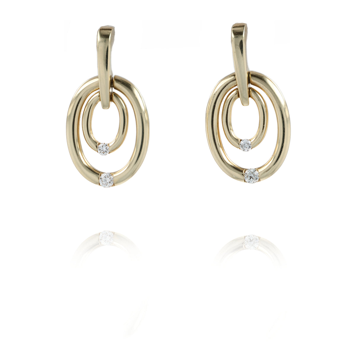 A pair of gold drop earrings with interlocking oval rings and small clear gemstone accents, shown on a white background with a faint reflection below.