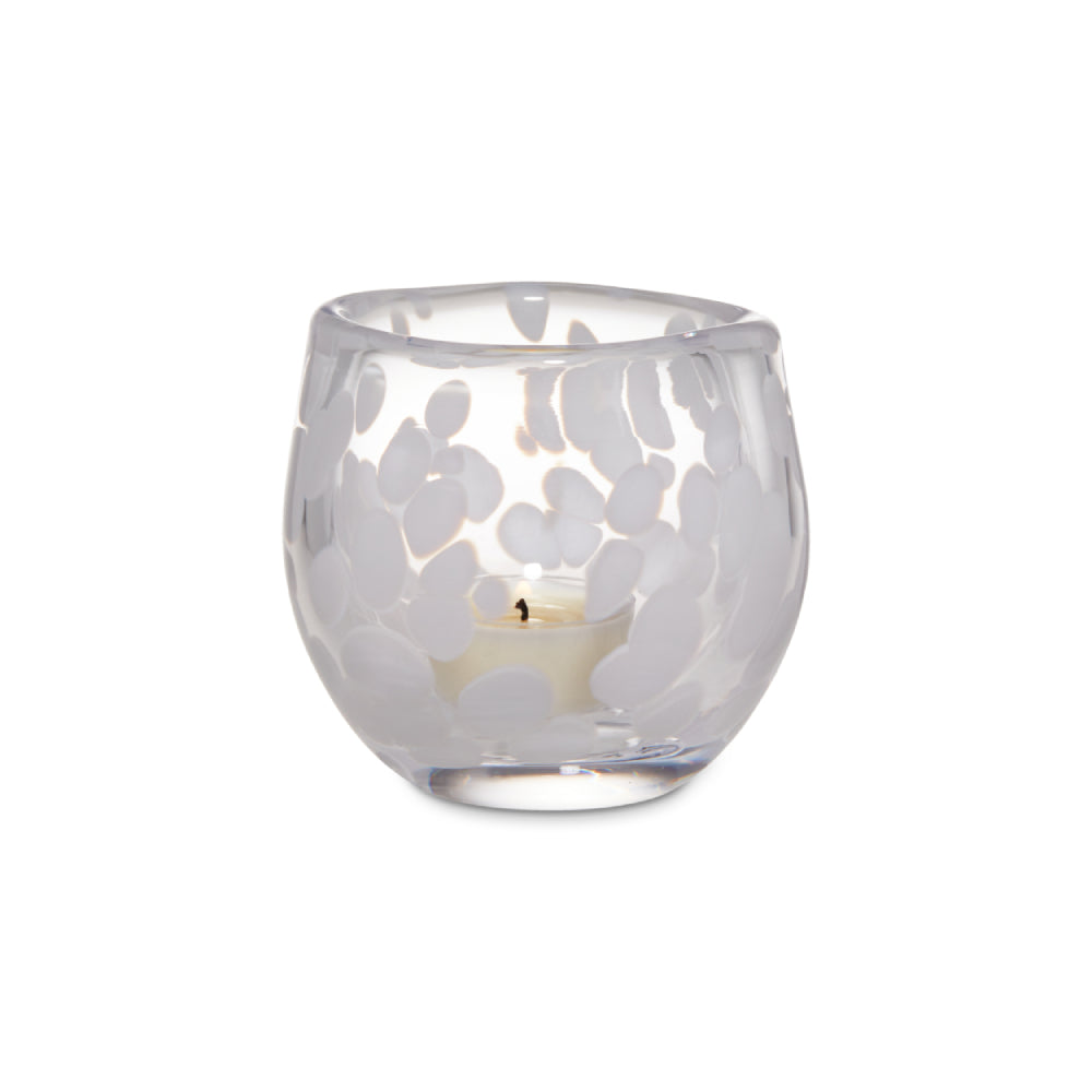 Clear glass candle holder with cut-out design on a white background