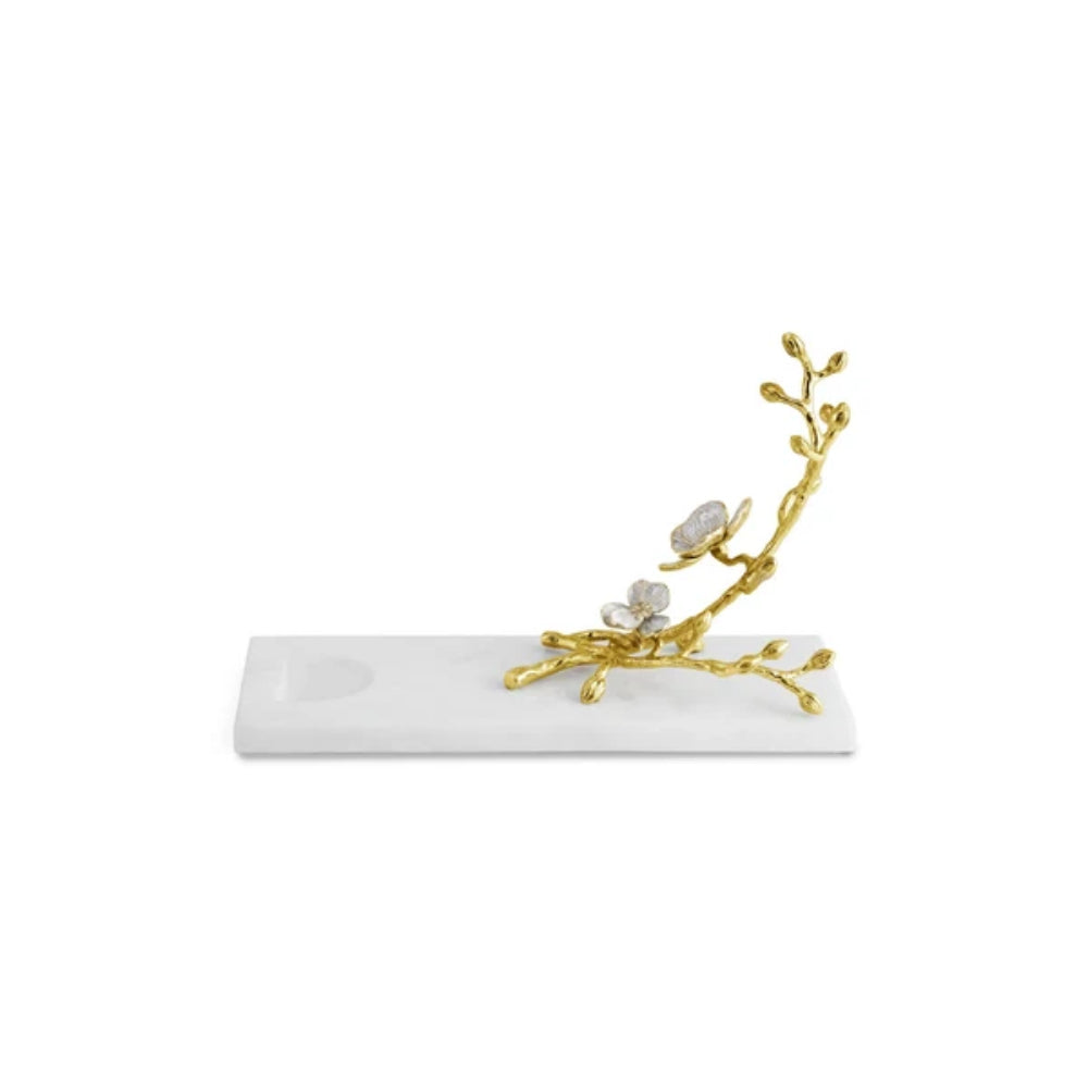 A decorative gold branch sculpture with white flowers and a rectangular white marble base, photographed on a clean white background. (Wine Rest)