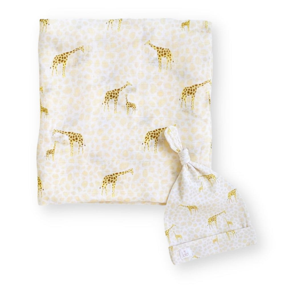 Baby blanket and hat set with giraffe pattern on a white background