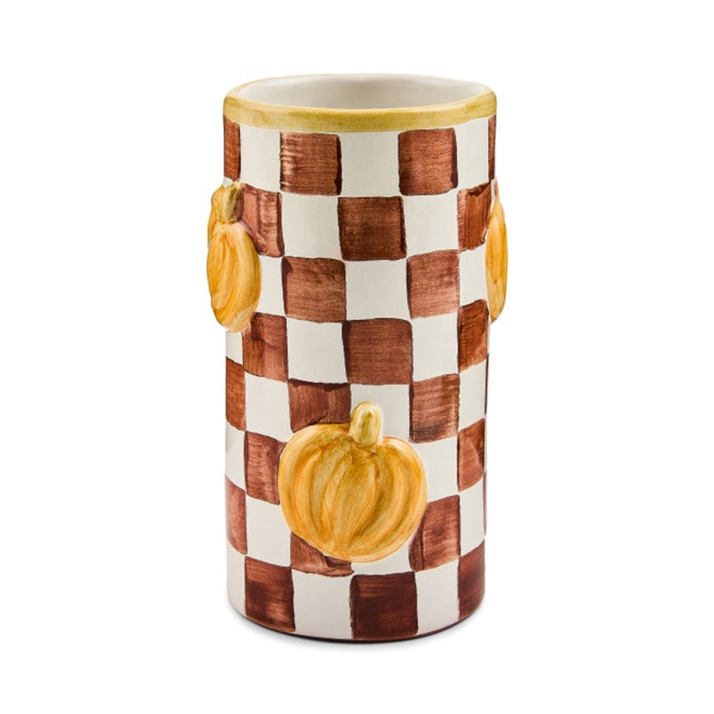 A cylindrical ceramic vase featuring a brown and white checkerboard pattern with three painted orange pumpkins on the front, set against a plain white background.