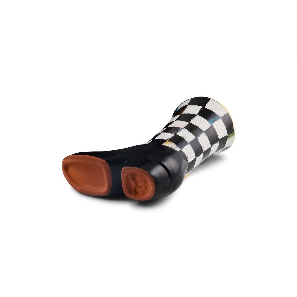 A single black leather boot with a black and white checkered pattern on the shaft and heel, featuring brown suede-like footbeds, shown on a plain white background.