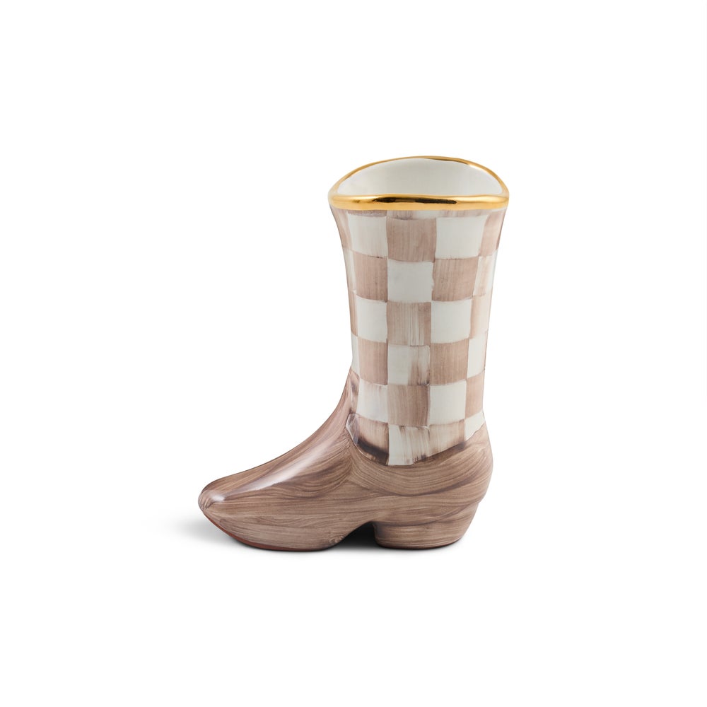 A ceramic cowboy boot planter with a brown and beige checkerboard pattern on the shaft, a brown footed base, and a gold rim at the top, shown on a white background.