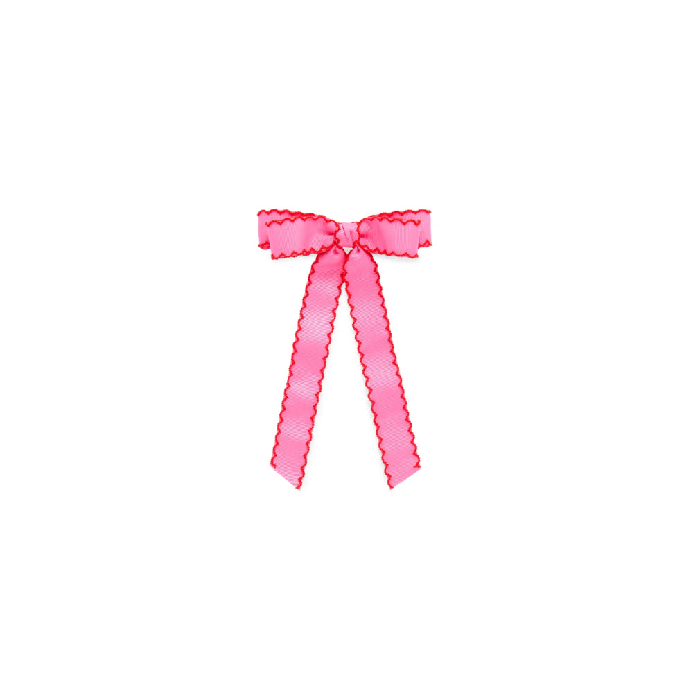 A bright pink ribbon bow with a scalloped edge, centered on a plain white background.