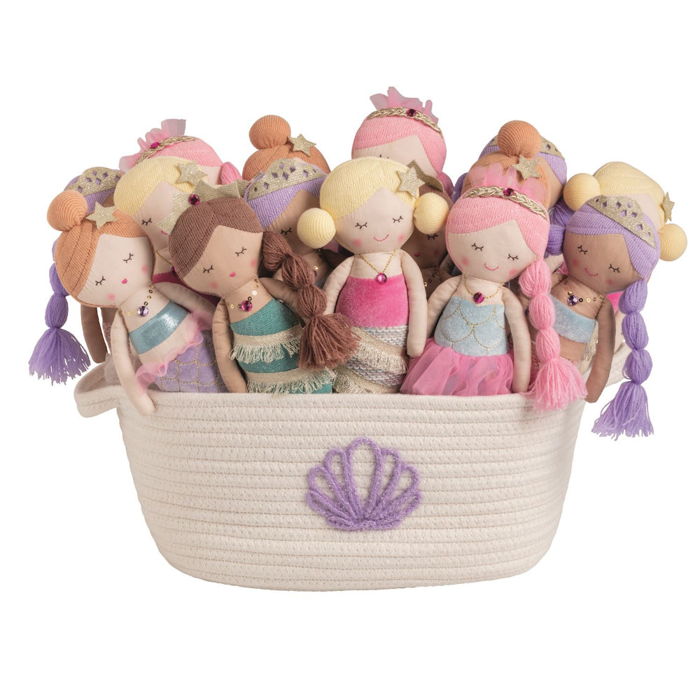Set of mermaid-themed dolls in a woven basket on a white background