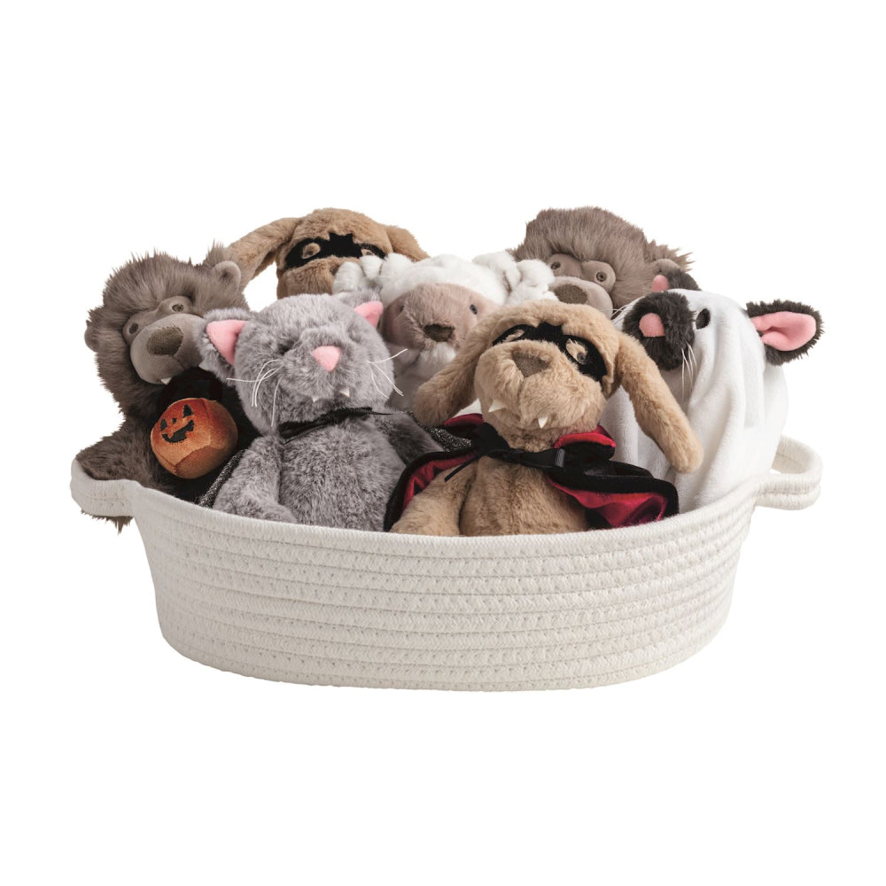 Basket filled with Halloween themed plush toys on a white background