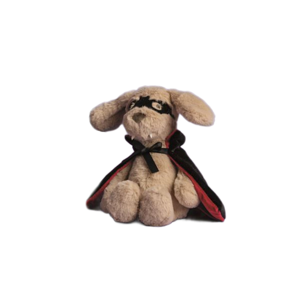 A plush stuffed dog toy dressed as a vampire, featuring a beige/tan body, black mask, and a black cape with red lining, shown against a plain white background.