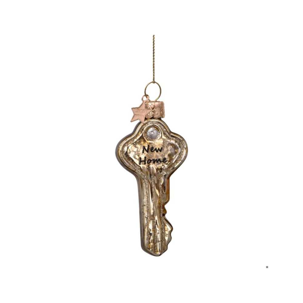 Decorative key ornament with 'New Home' text on a white background