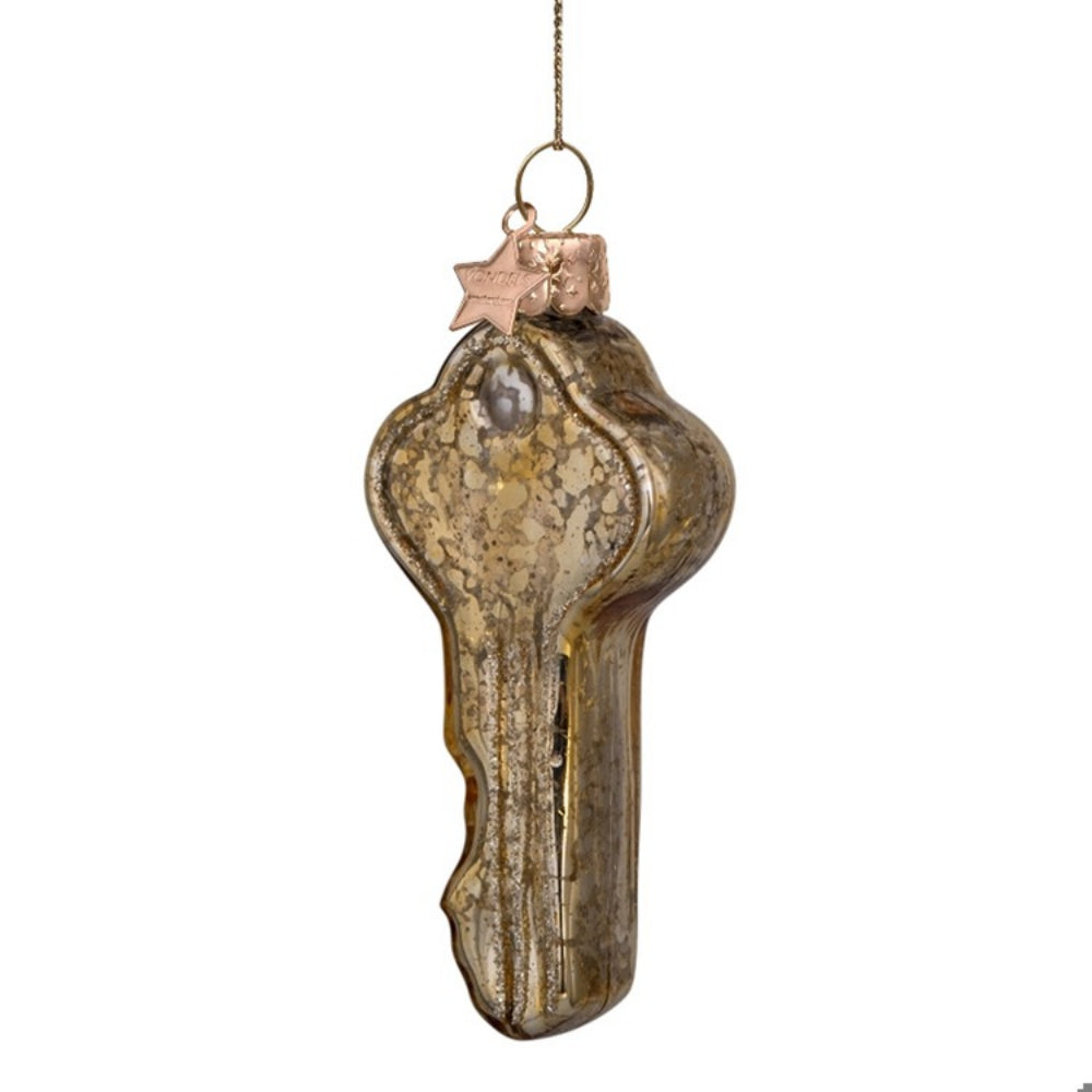 Decorative glass key ornament on a white background