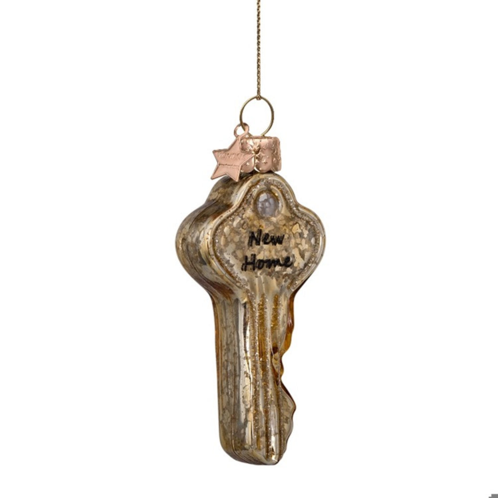 Decorative key ornament with 'New Home' text on a white background