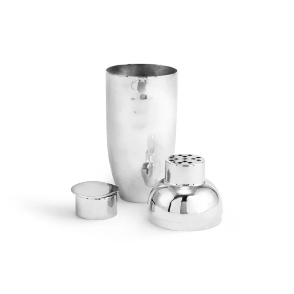 An silver stainless steel cocktail shaker, broken down to show all the pieces on a white background