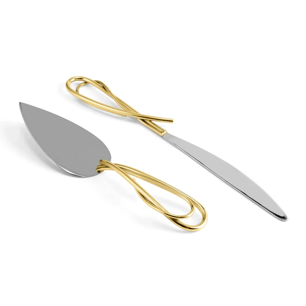 Two cake knives with gold handles on a white background