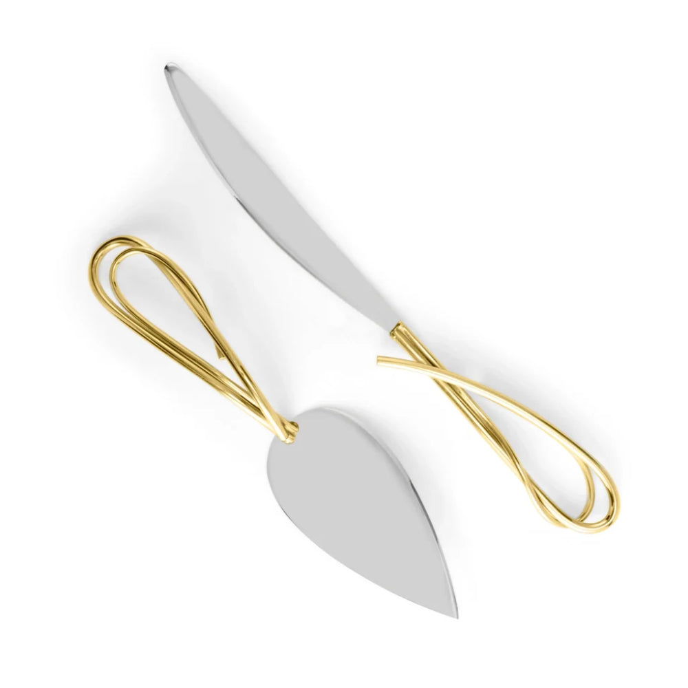 White cake server with gold handle on a white background
