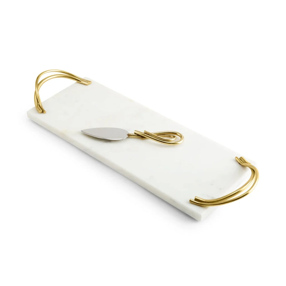 A rectangular white marble serving tray with rounded corners and gold metal handles, featuring a small gold and silver metal spoon resting on top, set against a plain white background.