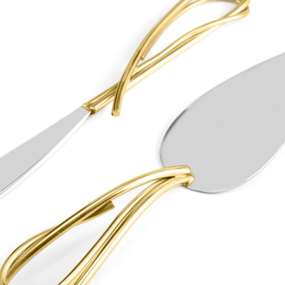 Close-up of a polished metal serving utensil with a twisted gold handle and a silver-toned blade on a white background.