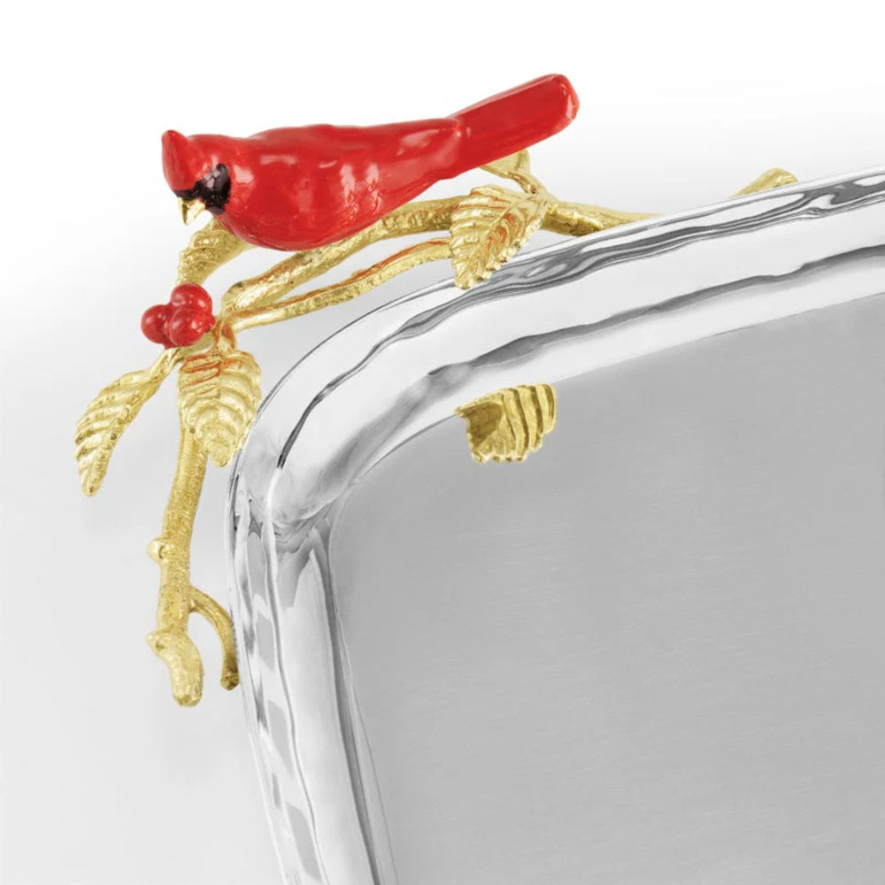 Decorative glass tray with red cardinal bird and gold branch on a white background
