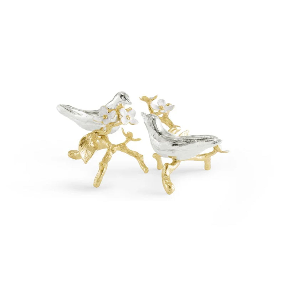 Pair of bird-shaped figurines with gold and silver finish on a white background