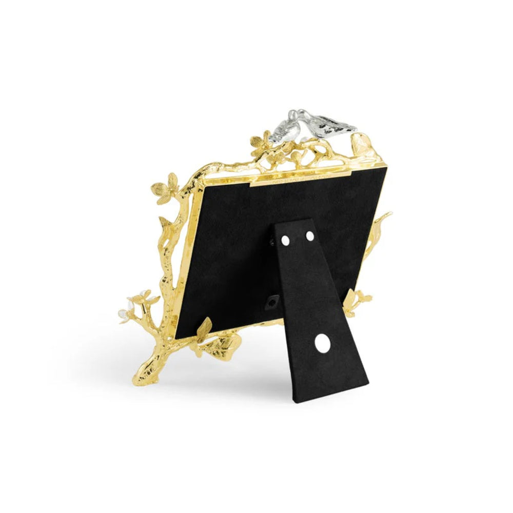Decorative photo frame with gold leaf design on a white background