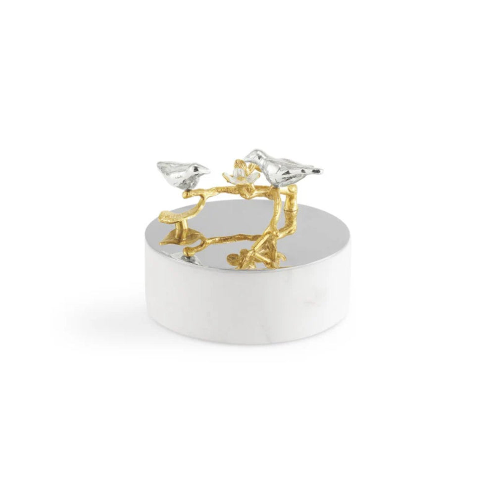 Decorative object with gold and silver birds on a white base.