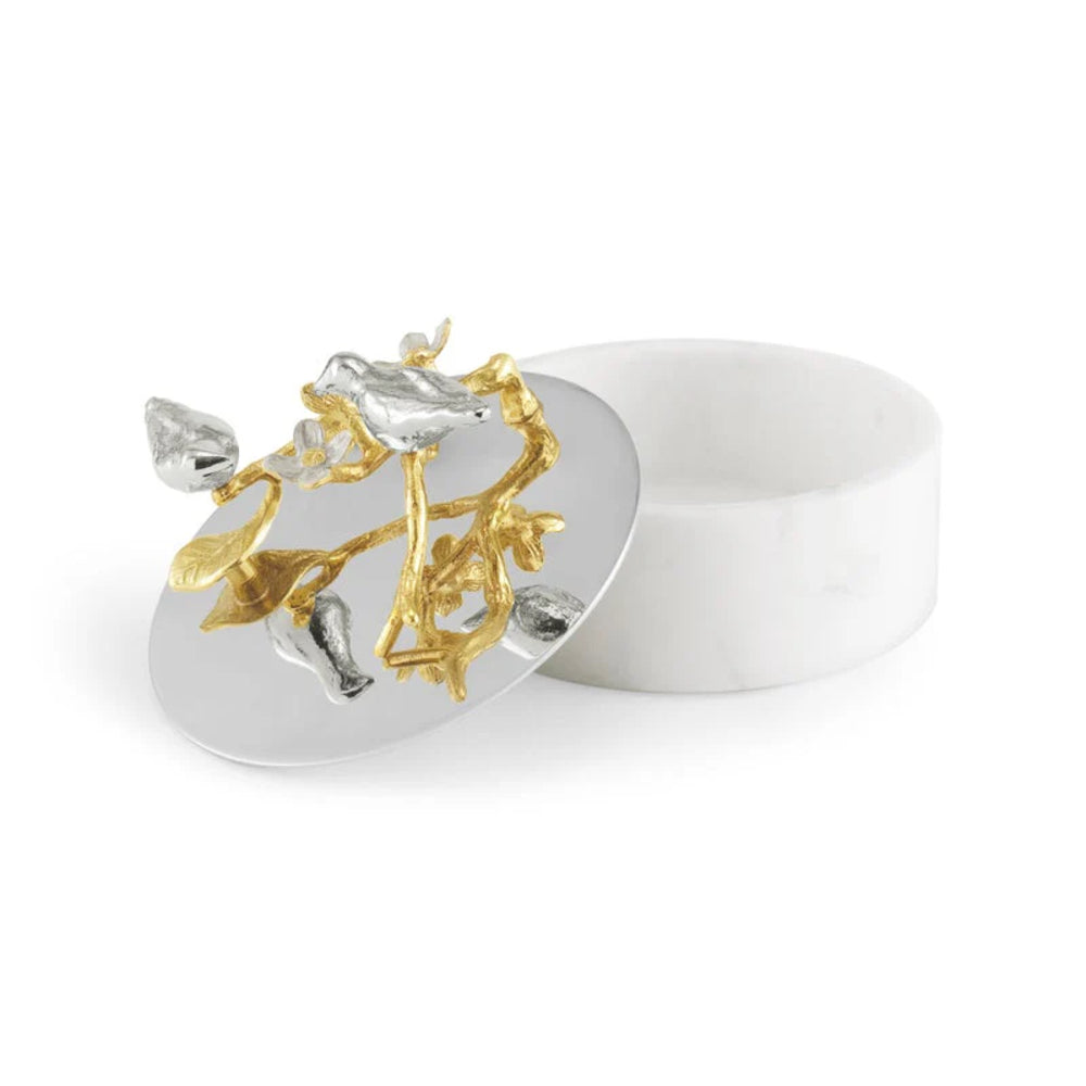 Silver and gold jewelry box with floral design on a white background.