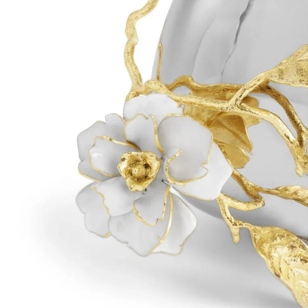 Close-up of a white flower with gold accents on a white background
