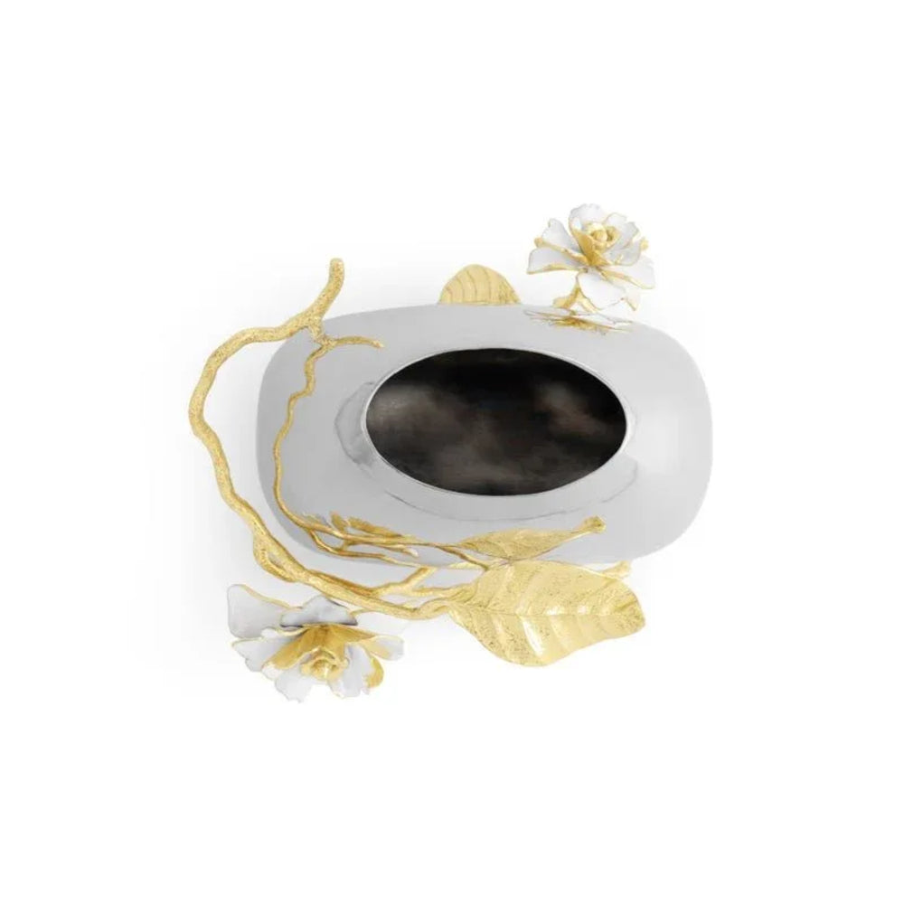 Decorative white dish with gold accents and floral designs on a white background