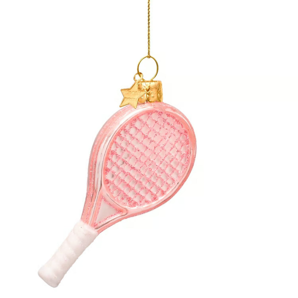 A pink tennis racket Christmas ornament with a white wrapped handle, gold hanging loop, and a small gold star charm, shown against a plain white background.