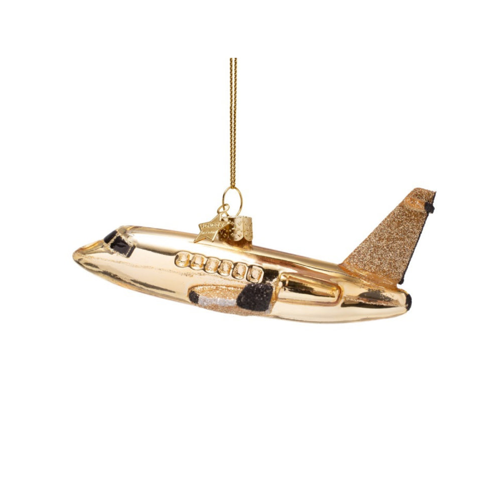 Gold airplane ornament on a white background