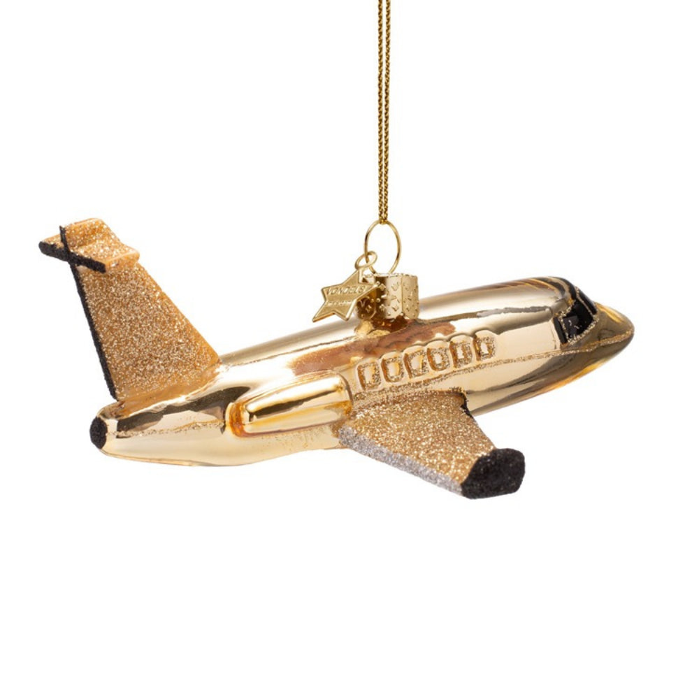Gold airplane ornament on a white background