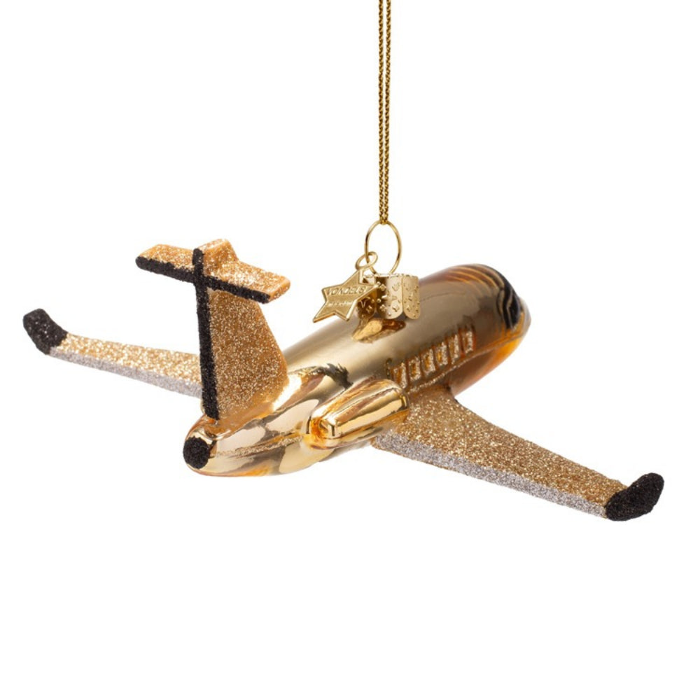 Gold airplane ornament on a white background