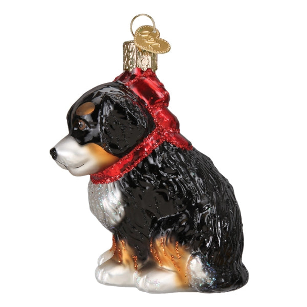 Glass ornament of a dog with a red collar on a white background.